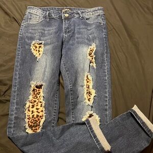 Women’s size Medium jeans. Leopard print in holes.